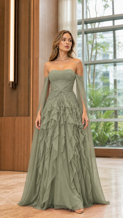 Model wearing sage green strapless evening gown with flowing cape sleeves