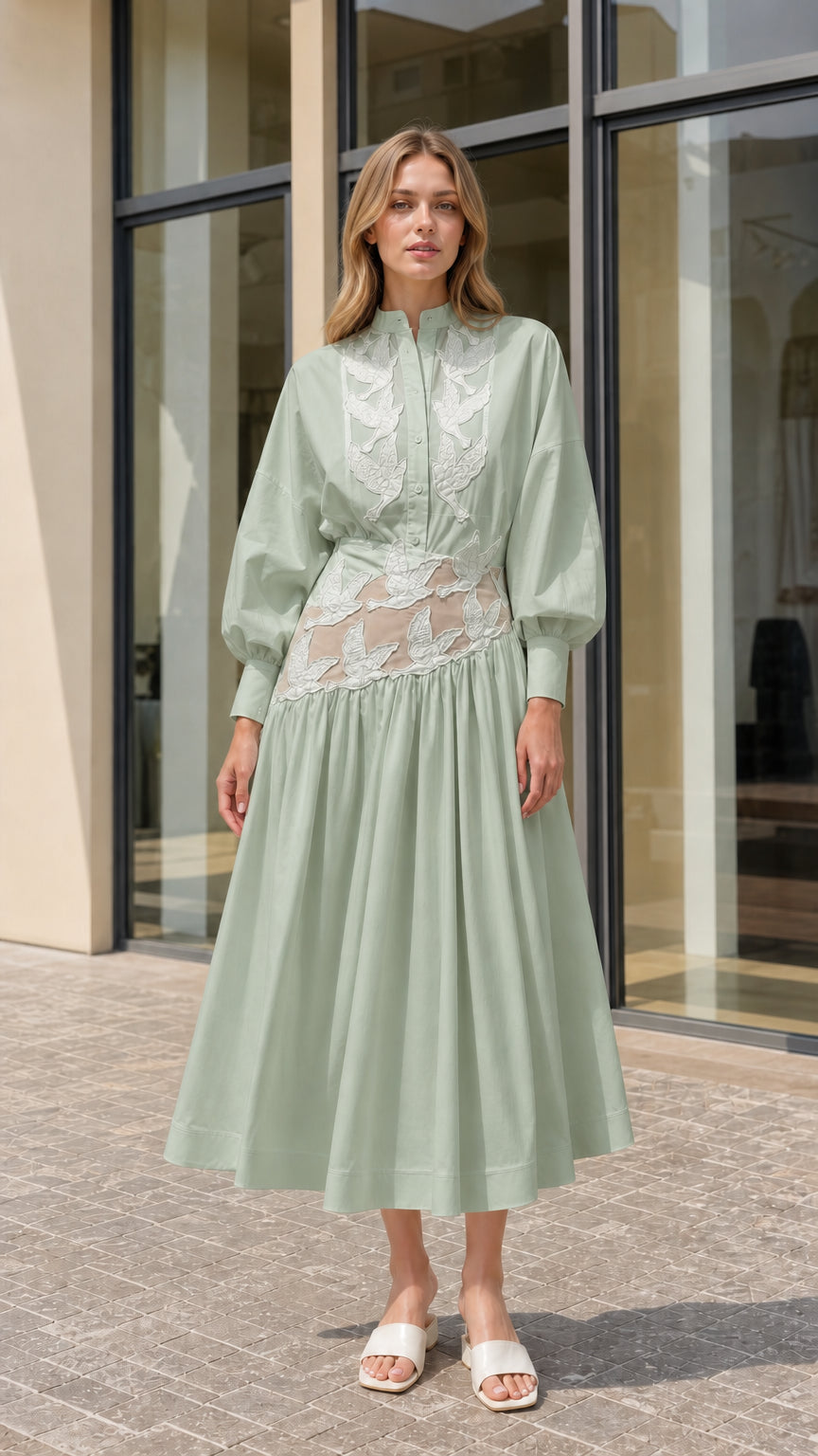Model wearing sage green embroidered lantern sleeve midi shirt dress