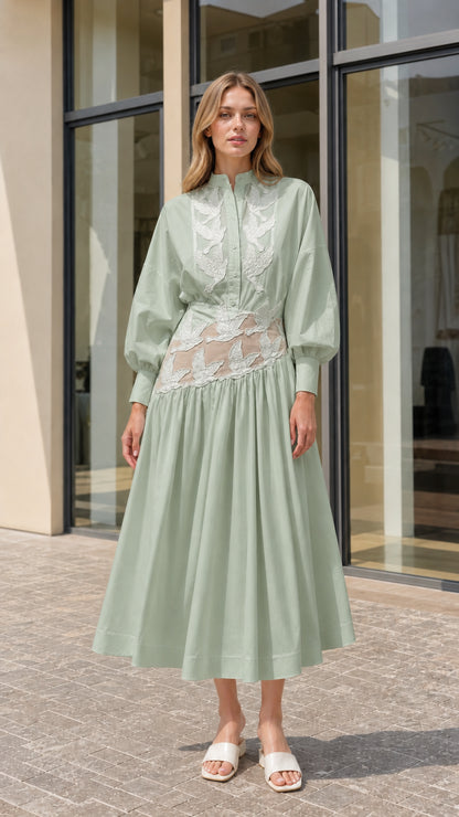 Model wearing sage green embroidered lantern sleeve midi shirt dress