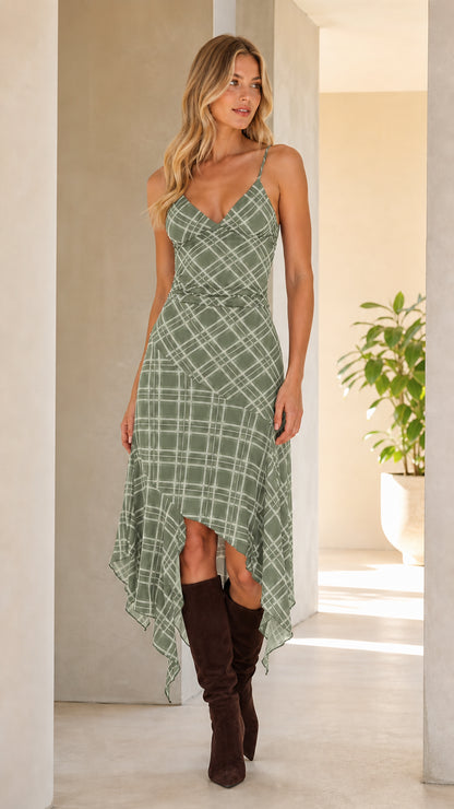 Front view of woman wearing green plaid asymmetrical cami midi dress