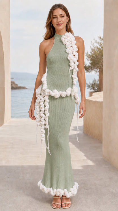 Full-length view of sage green halter neck ribbed knit maxi dress with cream pom pom trim