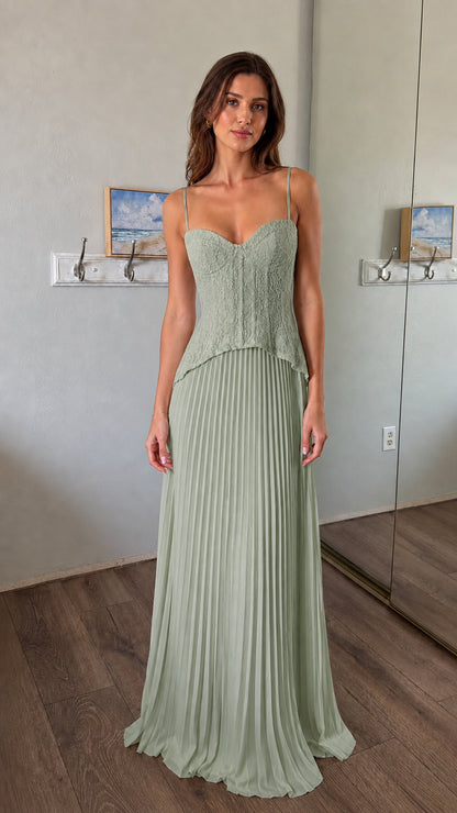 Front view of woman wearing sage green lace corset bodice pleated maxi dress