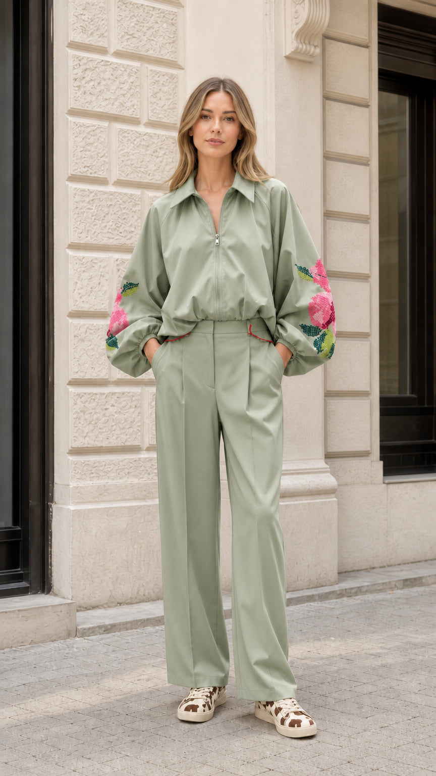 Model wearing sage green matching jacket and wide-leg pant set with floral embroidery