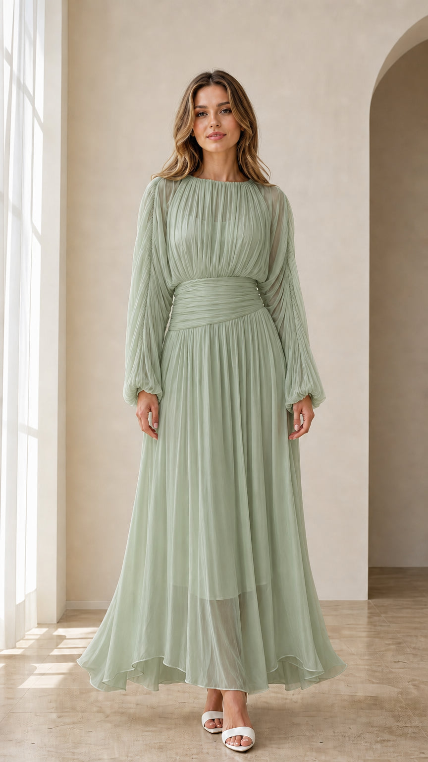 Model wearing sage green long sleeve pleated formal gown