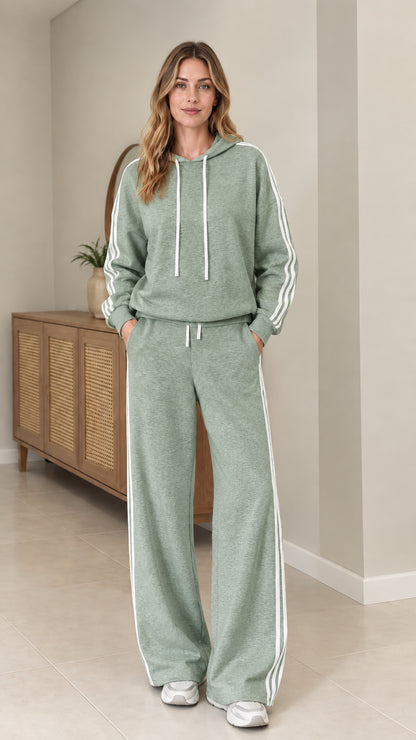 Model wearing Sage Green two-piece tracksuit set with white side stripes