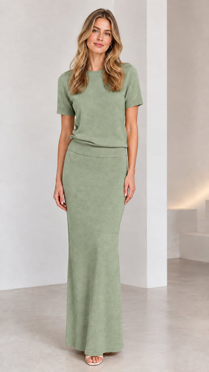 Front view of model wearing sage green knit top and maxi skirt set