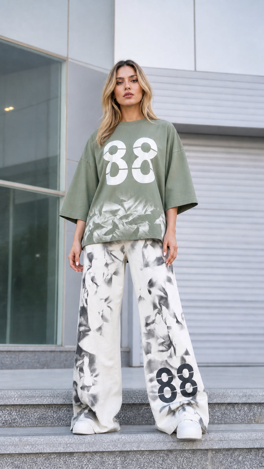 Front view of woman wearing sage green oversized graphic tee and matching wide-leg pants