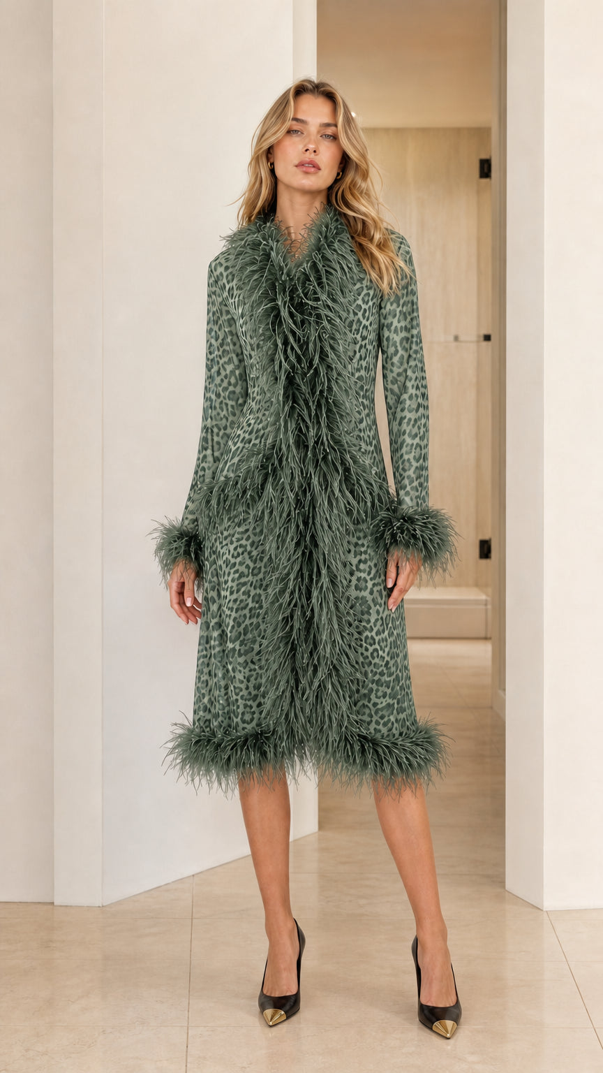 Model wearing the sage green leopard print midi coat with olive green feather trim