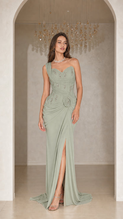 Woman wearing sage green one-shoulder pleated evening gown