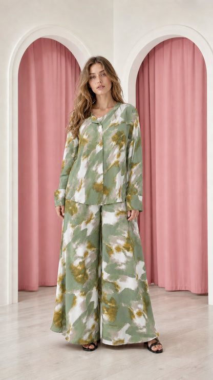 Model wearing sage green tie-dye satin top and wide-leg trousers set