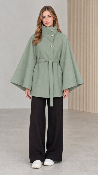 Front view of model wearing sage green high neck belted cape coat