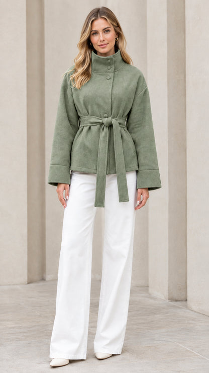 Front view of model wearing sage green stand collar belted short coat