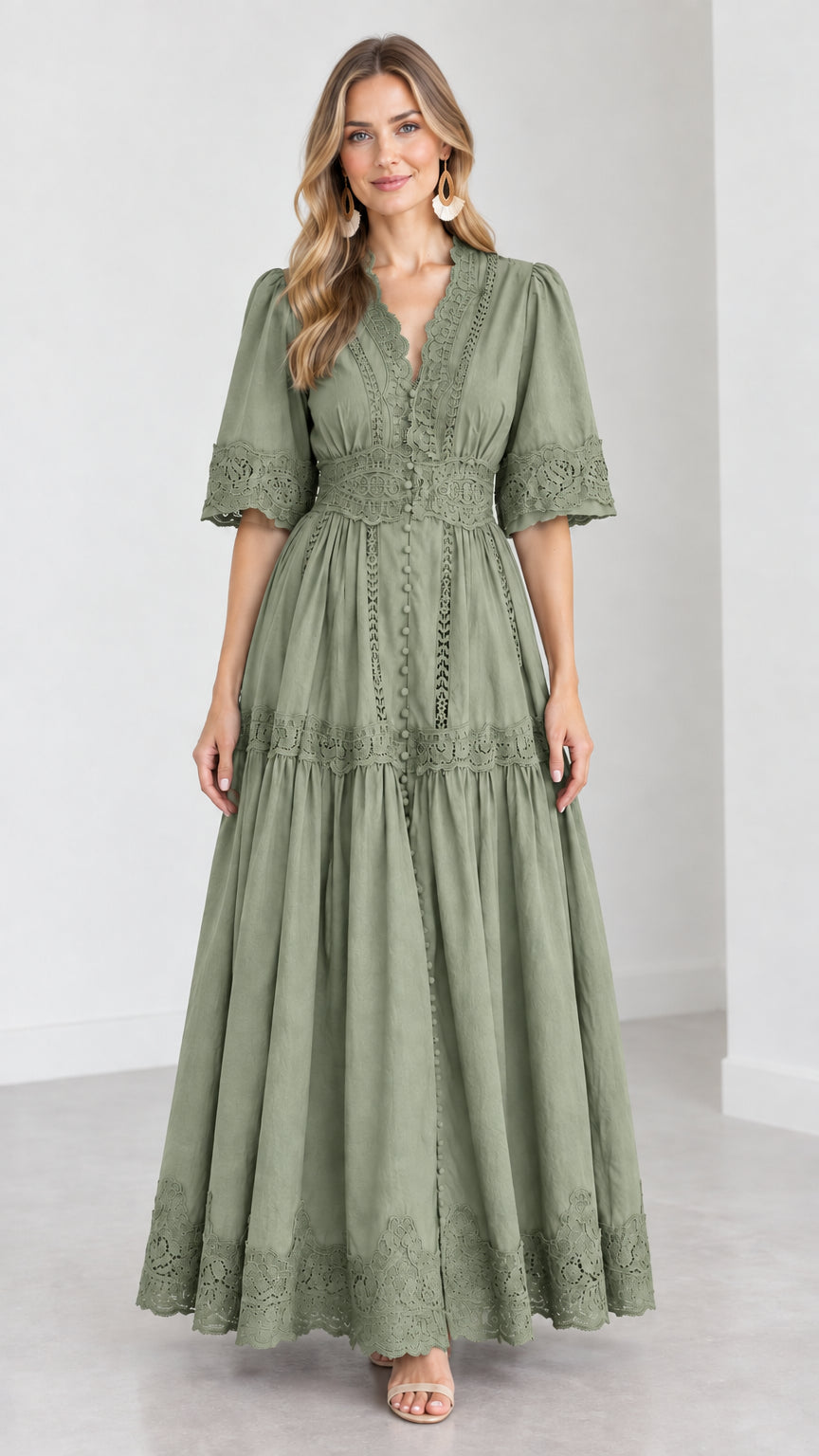 Front view of woman wearing a sage green V-neck lace trim tiered maxi dress