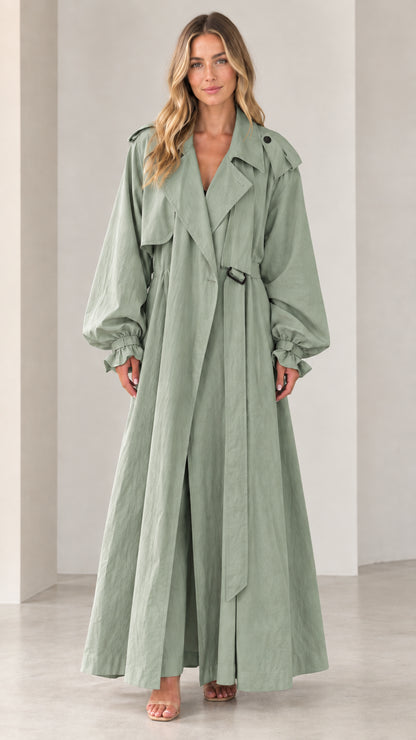 Front view of woman wearing full-length sage green belted maxi trench coat