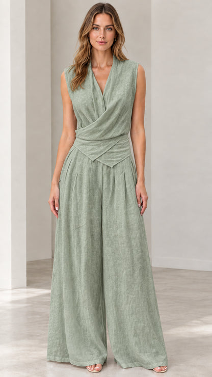 Front view of woman wearing sage green sleeveless wide-leg jumpsuit