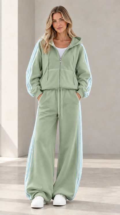 Model wearing sage green two-piece athletic tracksuit set with contrast side stripes