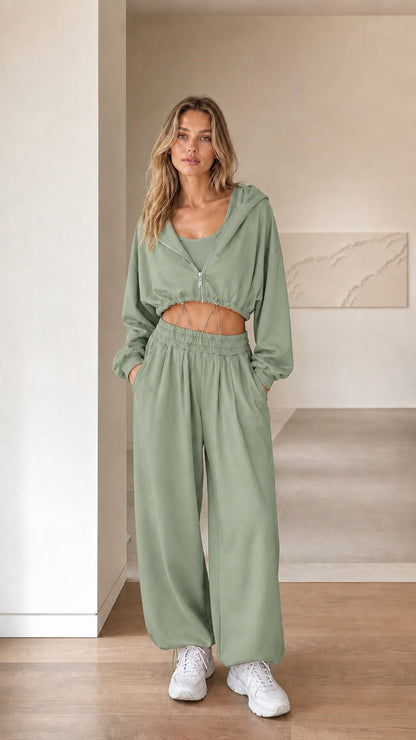 Front view of woman wearing sage green 3-piece cropped hoodie and sweatpants set