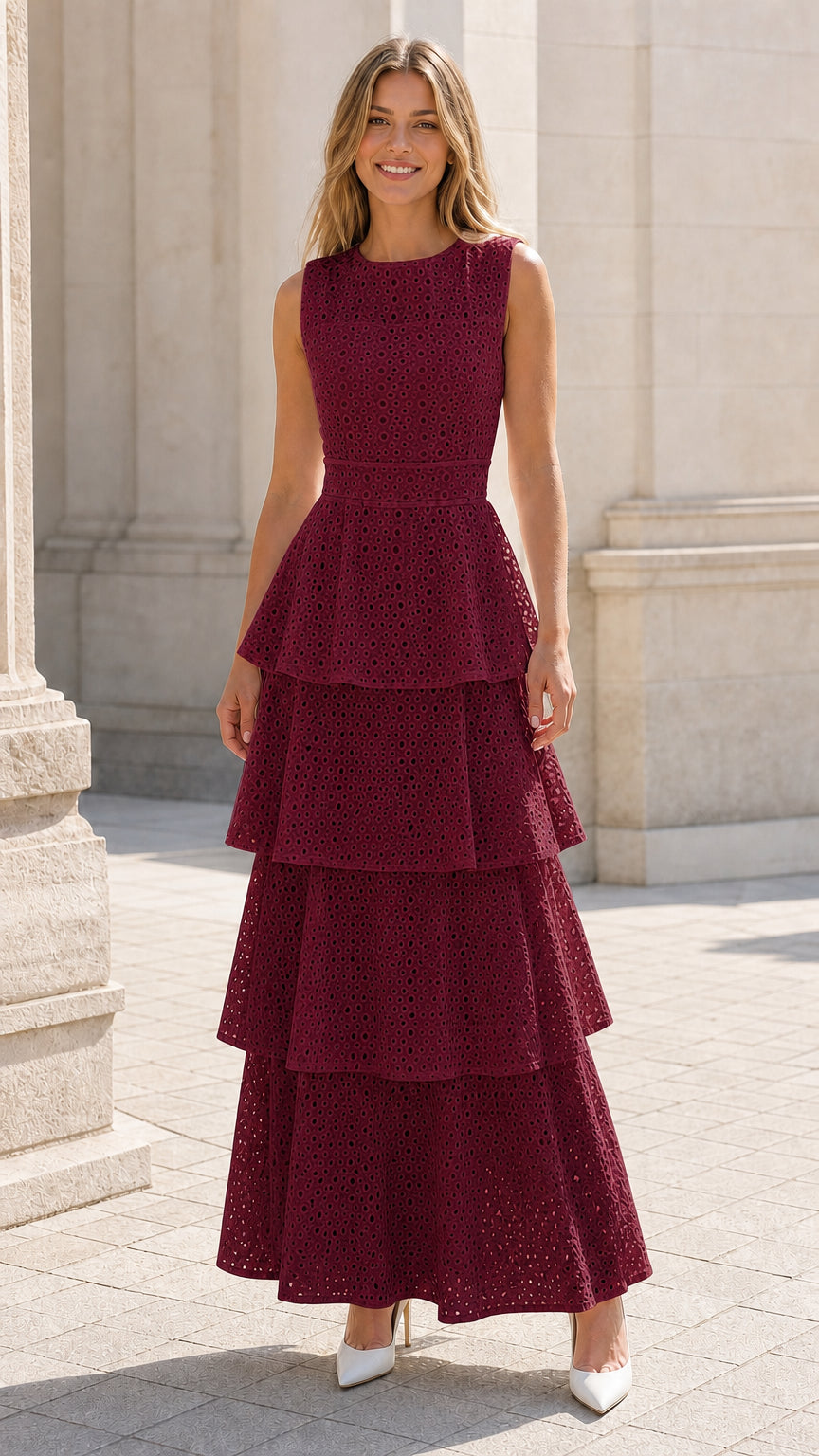 Front view of woman wearing burgundy tiered eyelet maxi dress