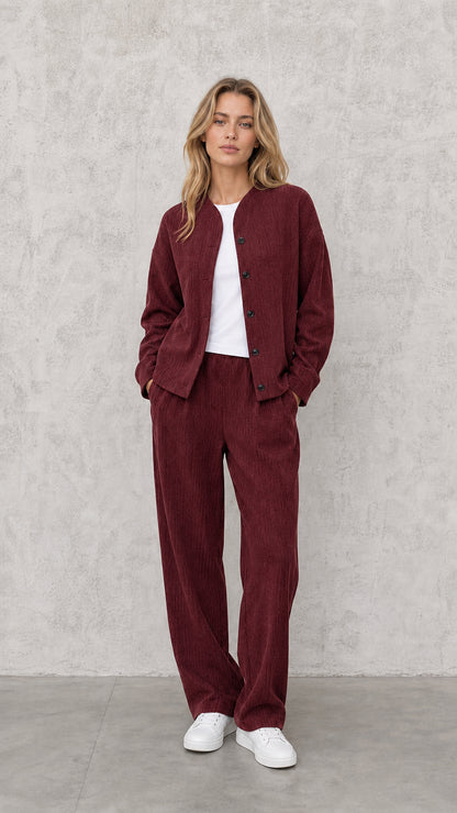 Model wearing Burgundy textured matching two-piece jacket and wide-leg pants set