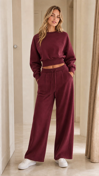 Woman wearing burgundy wine-red cropped lounge top and wide-leg pants set
