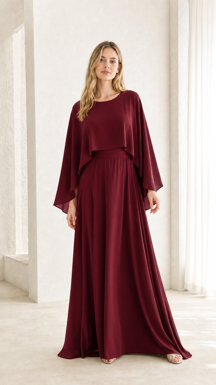 Woman wearing burgundy cape overlay maxi dress