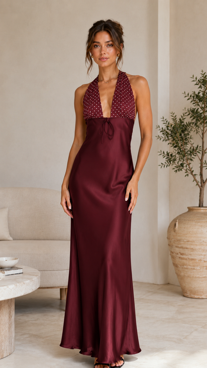 Front view of burgundy halter satin-look maxi dress with polka dot bodice