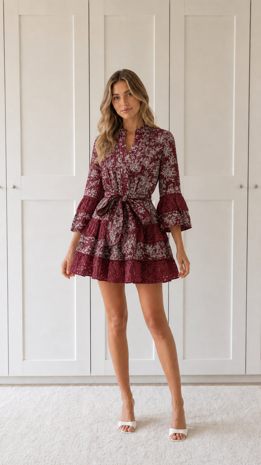 Front view of woman wearing burgundy floral print ruffle mini dress
