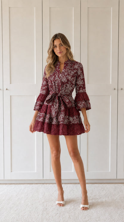 Front view of woman wearing burgundy floral print ruffle mini dress