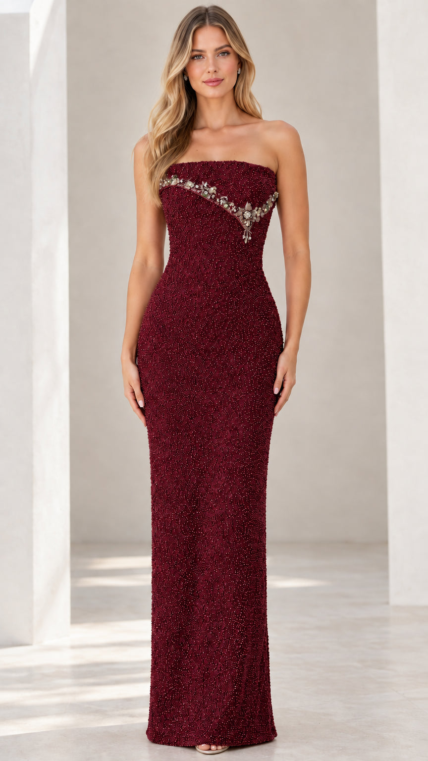 Front view of burgundy strapless beaded floor-length formal dress