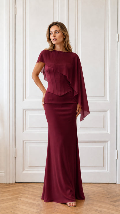 Model wearing burgundy formal cape evening dress