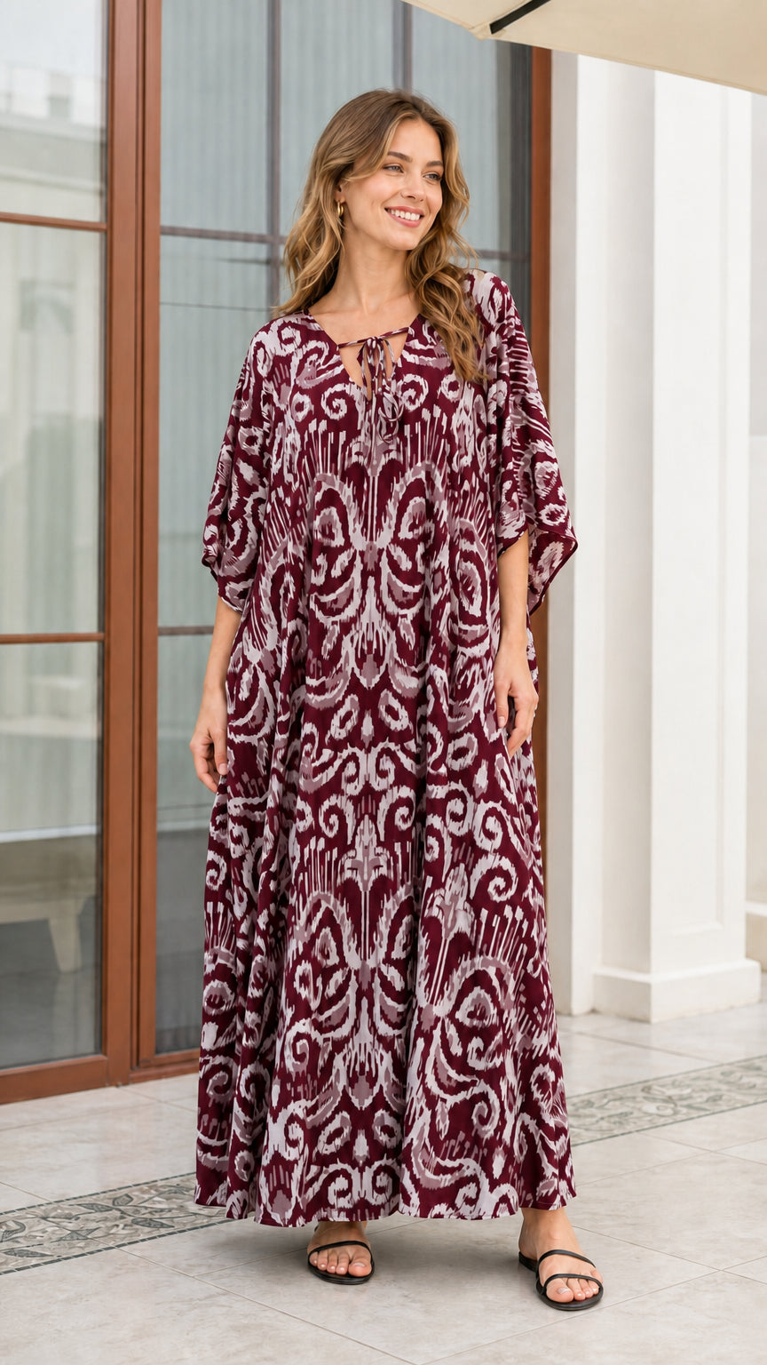 Front view of woman wearing rich burgundy wine printed maxi kaftan dress