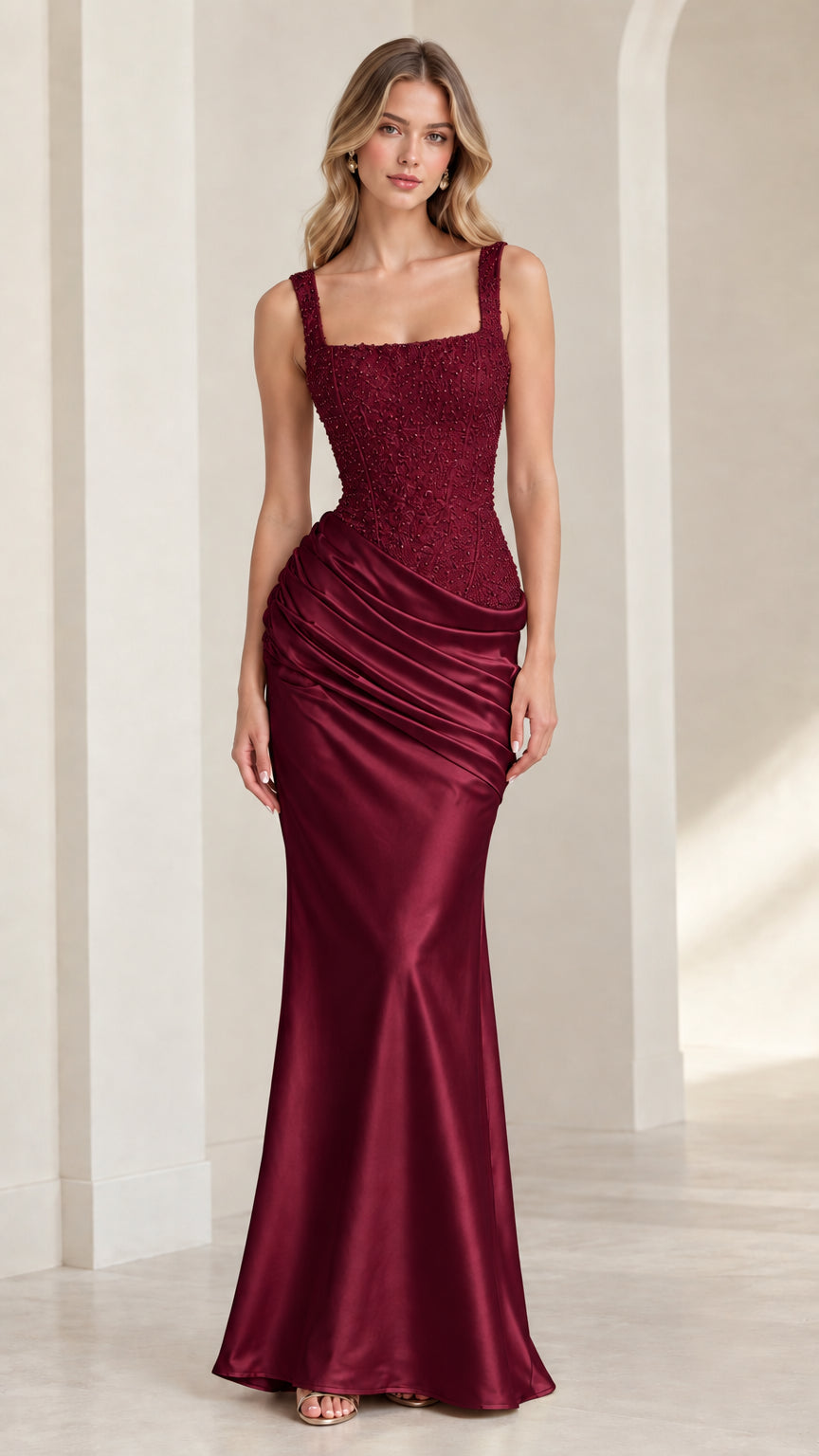 Model wearing rich burgundy ruched satin floor-length gala dress