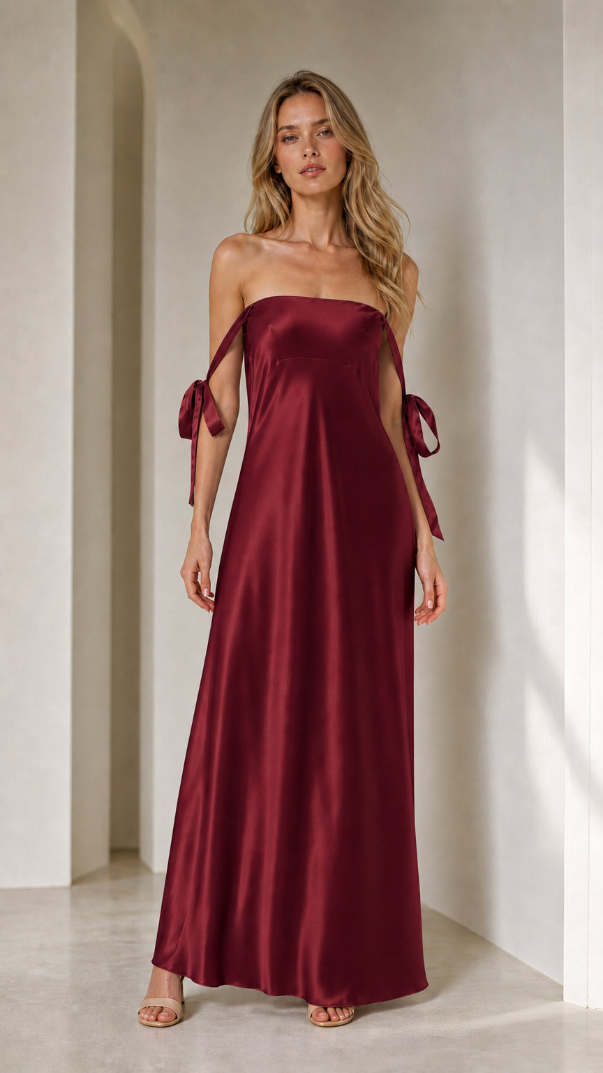 Model wearing burgundy satin strapless maxi dress