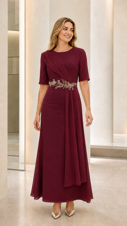 Front view of model wearing burgundy wine floor-length evening dress with side drape