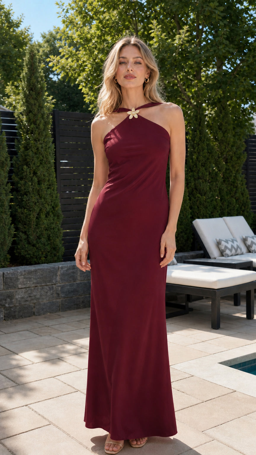Front view of model wearing burgundy red halter backless maxi gown