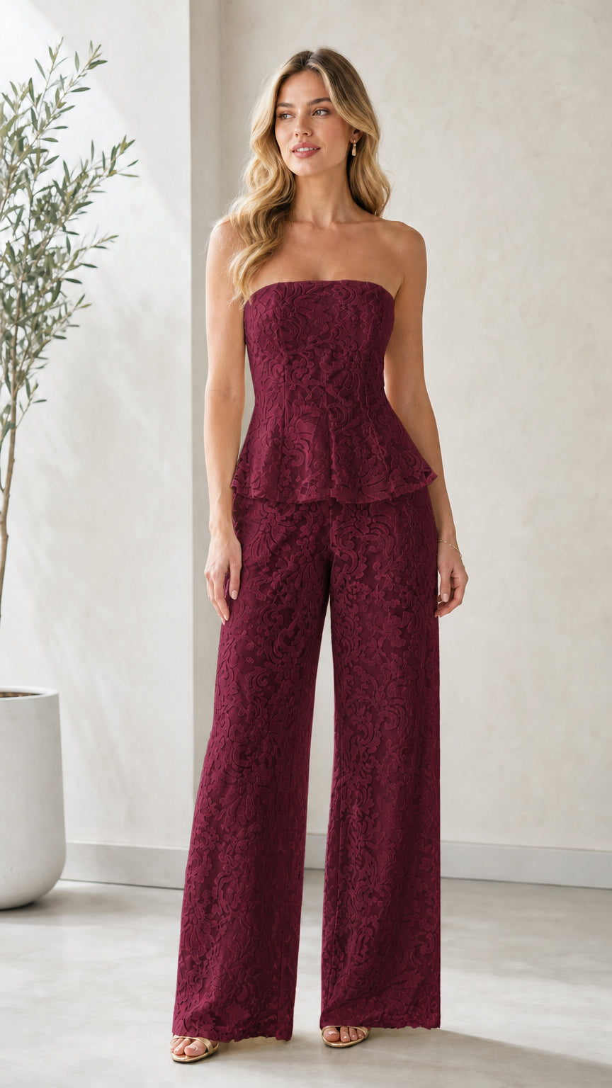Model wearing burgundy red strapless lace peplum wide leg jumpsuit