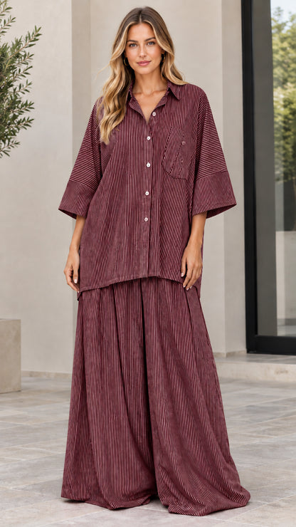 Woman wearing burgundy red striped oversized button-up and wide-leg pants set