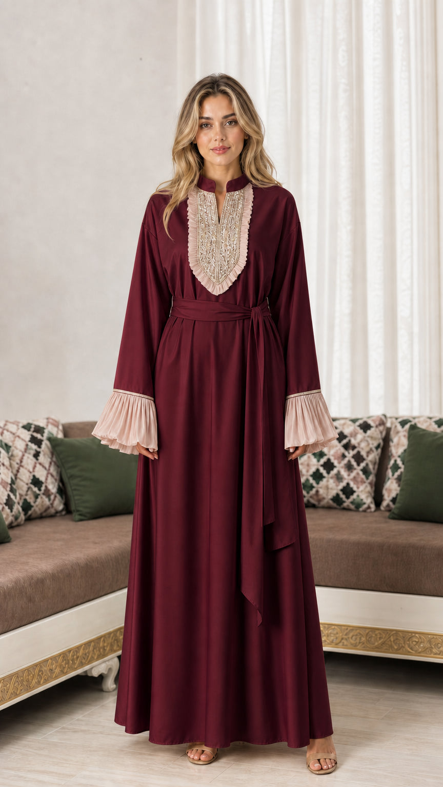 Front view of woman wearing burgundy wine embroidered maxi abaya dress with tie belt