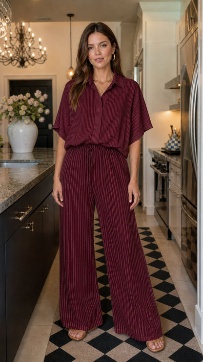 Woman wearing burgundy matching button down shirt and striped wide leg pants