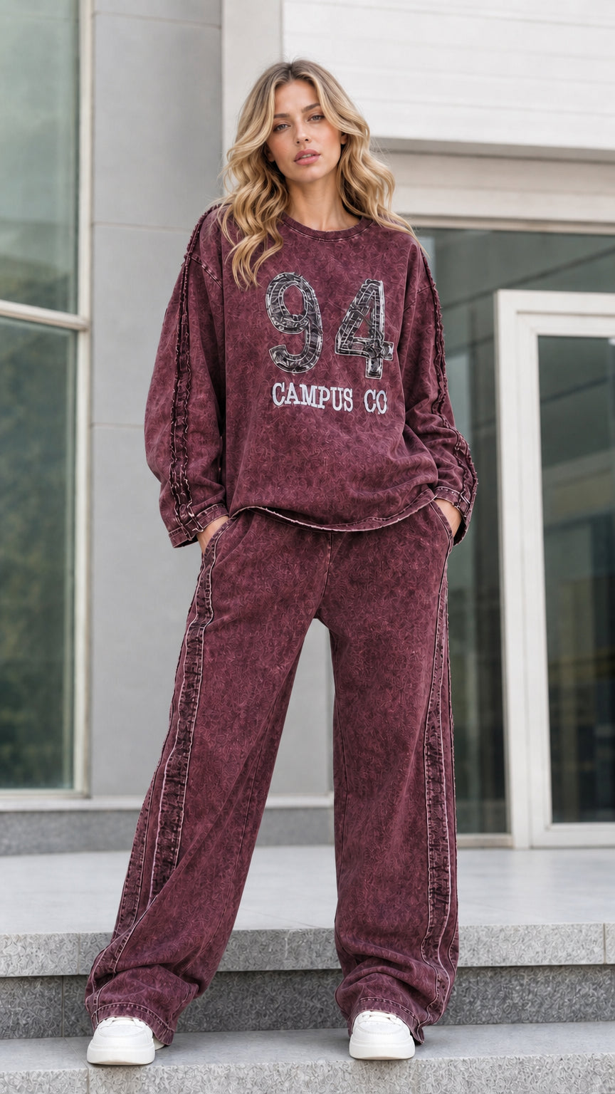 Full-length front view of burgundy wine red washed graphic sweatshirt and wide leg pants set