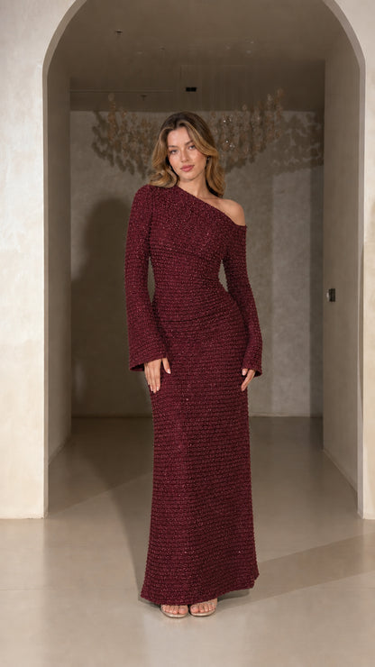 Model wearing Burgundy one-shoulder long sleeve textured evening gown