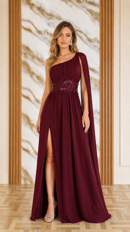 Front view of woman wearing burgundy one-shoulder cape evening dress