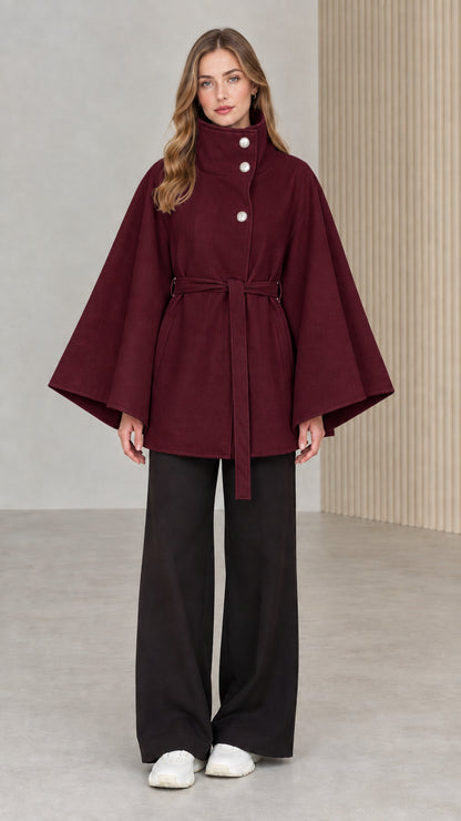 Front view of model wearing burgundy wine high neck belted cape coat