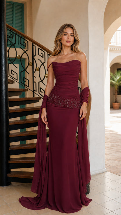 Model wearing rich burgundy floor-length strapless gown with coordinating shawl