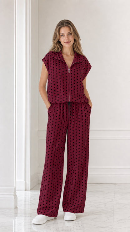 Model wearing burgundy red polka dot two-piece set with wide leg pants