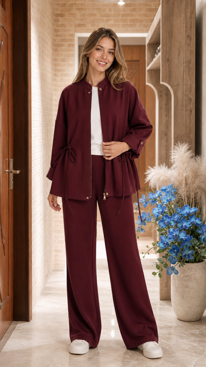 Model wearing Burgundy two-piece zip jacket and wide-leg pant set