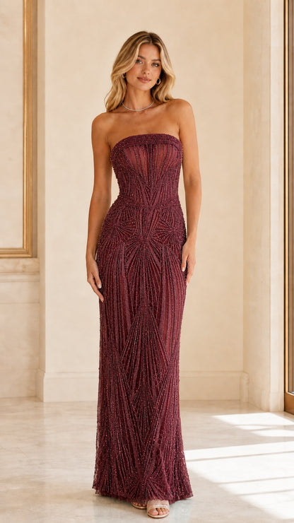 Model wearing deep burgundy wine strapless beaded evening gown