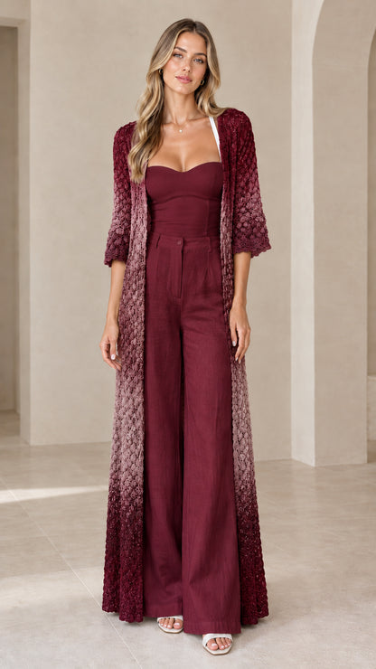 Front view of woman wearing Burgundy Multi ombré crochet maxi duster cardigan over matching wine jumpsuit