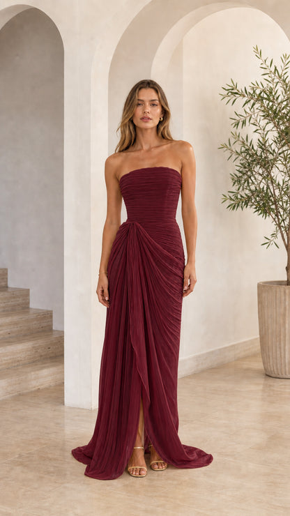Model wearing burgundy wine strapless draped maxi gown