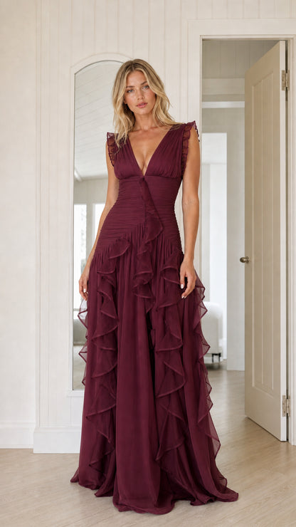Woman wearing burgundy wine colored v-neck cascading ruffle maxi dress